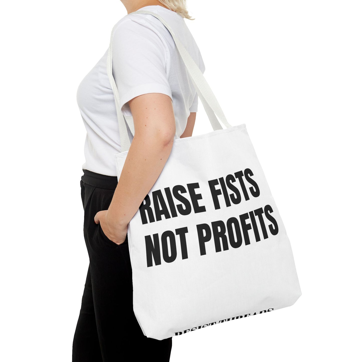 RAISE FISTS NOT PROFITS Tote bag.