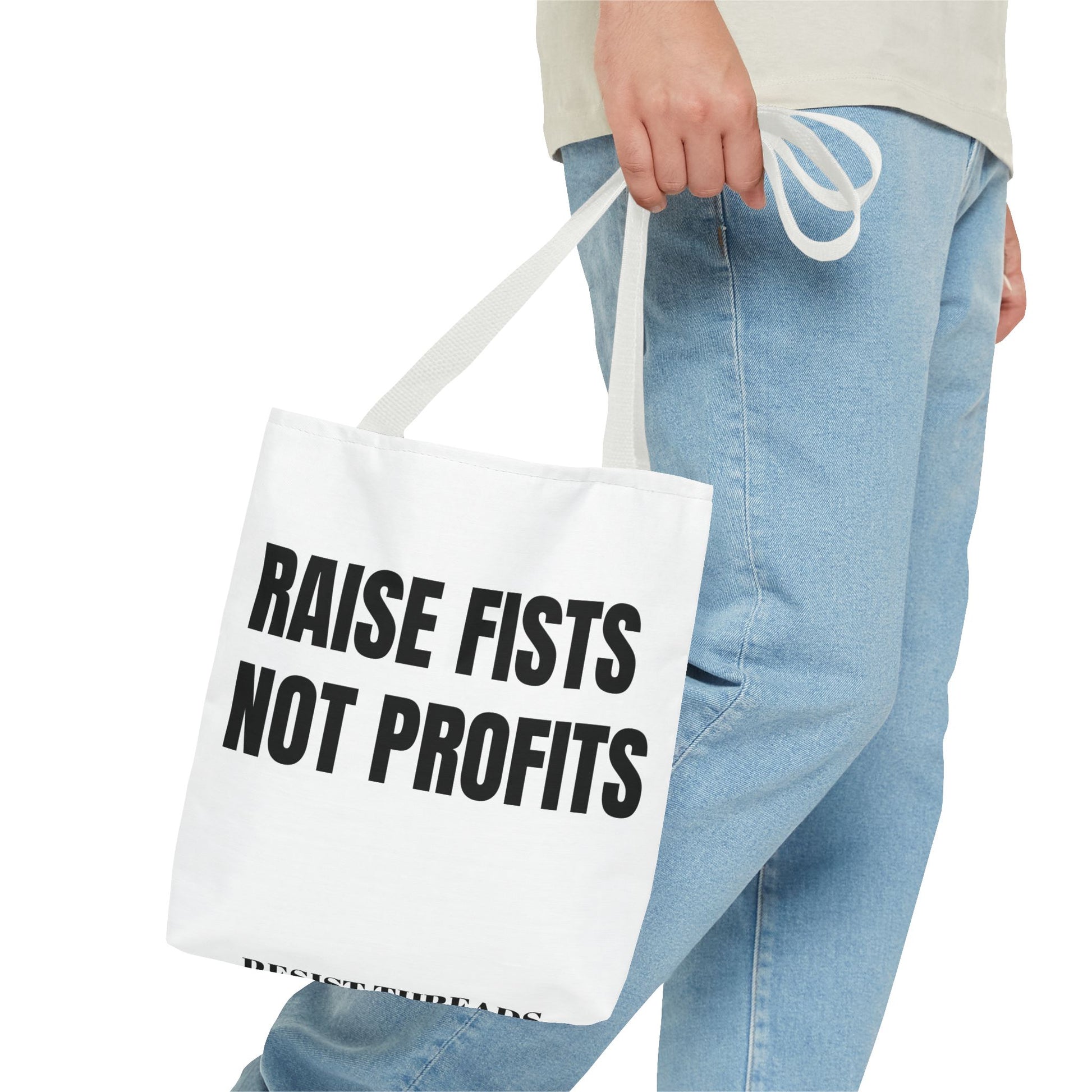 RAISE FISTS NOT PROFITS Tote bag.